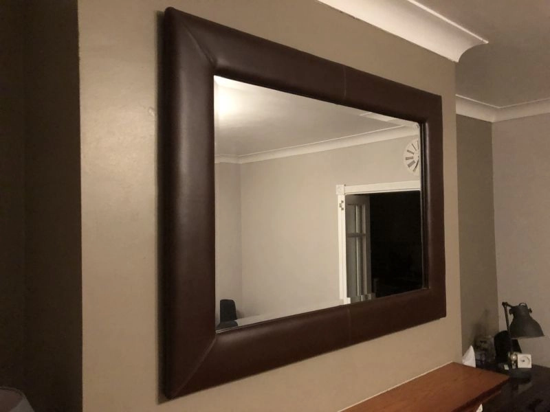 Faux leather framed mirror