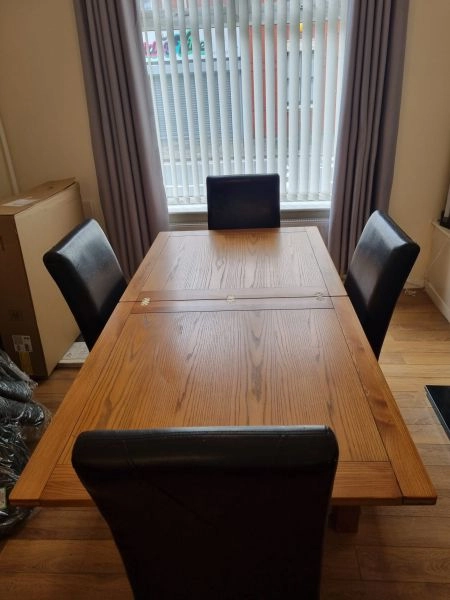 Harvey’s solid wood dinning table, chairs and matching sideboard