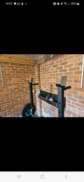 Squat rack with weights and bar.