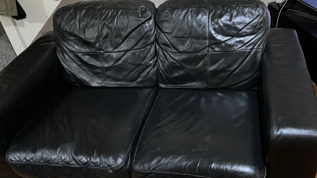 Two seated black leather sofa